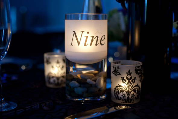 Labeled Vases with Floating Candles These simple and chic table numbers not
